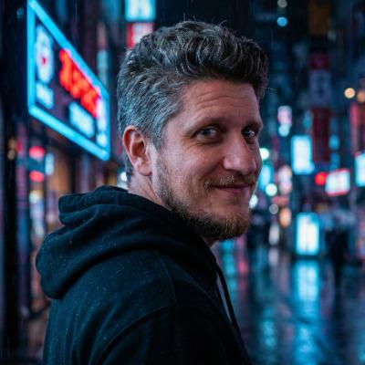 Kacper, creator of Solvie, in a black hoodie against a city at night